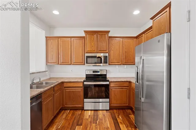 a kitchen with a sink appliances and cabinets