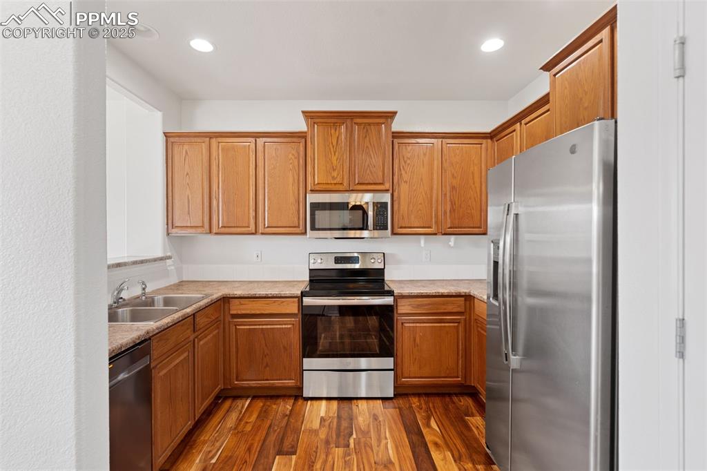 1243 Timber Run Heights Monument, CO 80132 - Photo 9 of 34 a kitchen with a sink appliances and cabinets