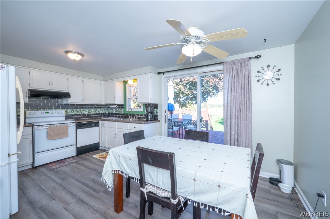 6463 Ward Road Sanborn, NY 14132 - Photo 20 of 49 A spacious dining area integrates seamlessly with the functional kitchen layout.