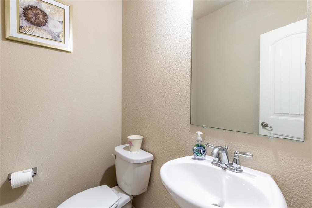 504 Rocky Pine Road McKinney, TX 75072 - Photo 11 of 36 Half bath featuring a sink and toilet