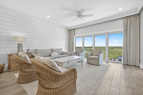 a living room with furniture and kitchen view