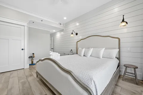 a view of a livingroom with wooden floor and flat screen tv
