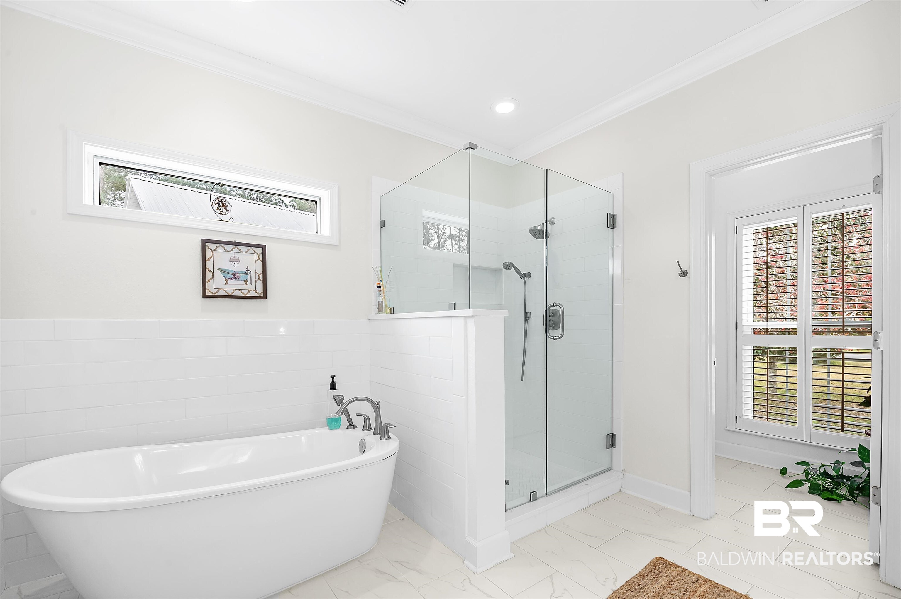 8915 Bay Point Drive Elberta, AL 36530 - Photo 56 of 74 Full bathroom with marble finish floor, crown molding, a freestanding bath, a shower stall, and recessed lighting