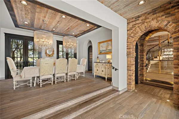 a living room with patio furniture and a chandelier