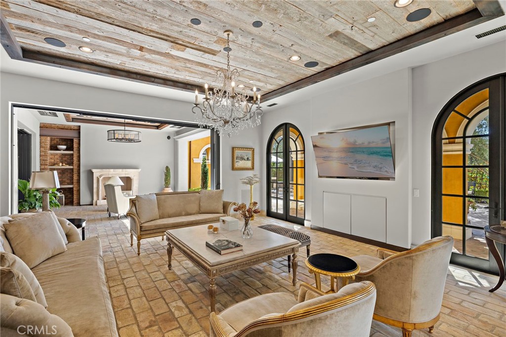 12 Thomas Road Ladera Ranch, CA 92694 - Photo 22 of 70 a living room with fireplace furniture and a chandelier