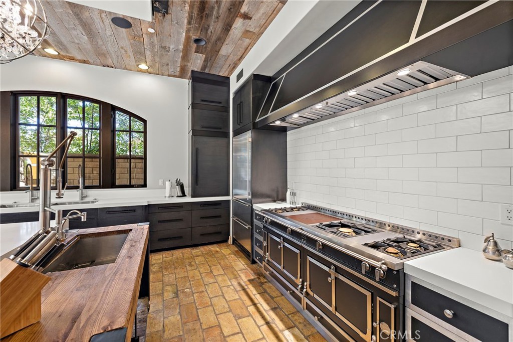 12 Thomas Road Ladera Ranch, CA 92694 - Photo 24 of 70 a kitchen with a stove a sink and a refrigerator