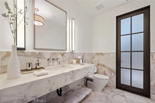 a bathroom with a sink a toilet and shower curtain