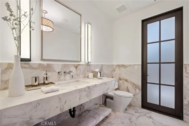 a bathroom with a sink a toilet and shower curtain