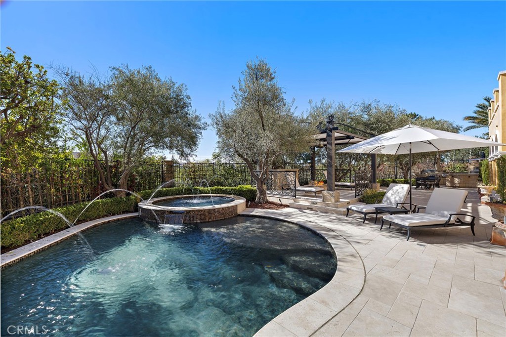 12 Thomas Road Ladera Ranch, CA 92694 - Photo 4 of 70 a view of swimming pool with outdoor seating and trees in the background