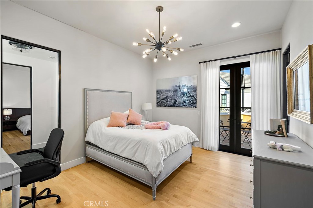 12 Thomas Road Ladera Ranch, CA 92694 - Photo 45 of 70 a bedroom with a large bed and a chandelier