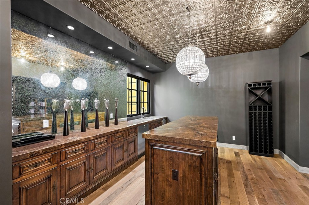 12 Thomas Road Ladera Ranch, CA 92694 - Photo 52 of 70 a kitchen with stainless steel appliances granite countertop cabinets a sink a stove a dining table and chairs