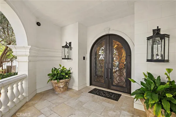 a living room with furniture a fireplace and a chandelier