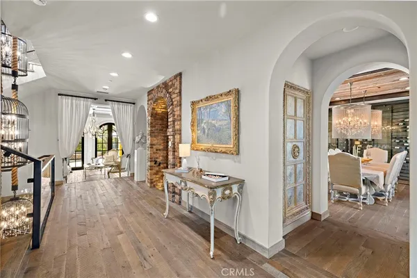 a living room with furniture a fireplace and a chandelier