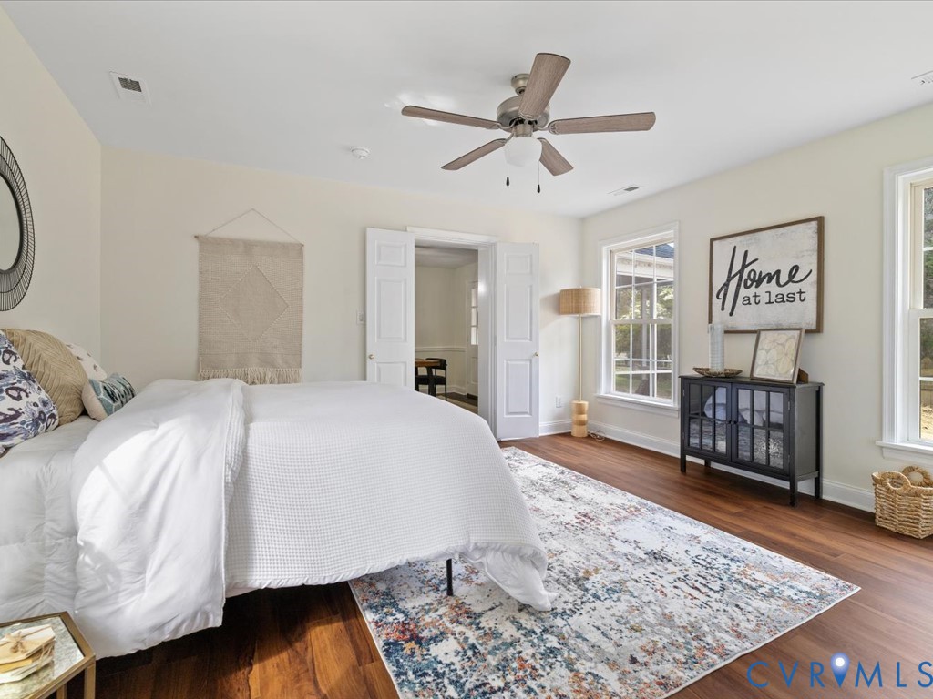 4803 Morrison Road Richmond, VA 23230 - Photo 27 of 45 a spacious bedroom with a bed a dresser and wooden floor
