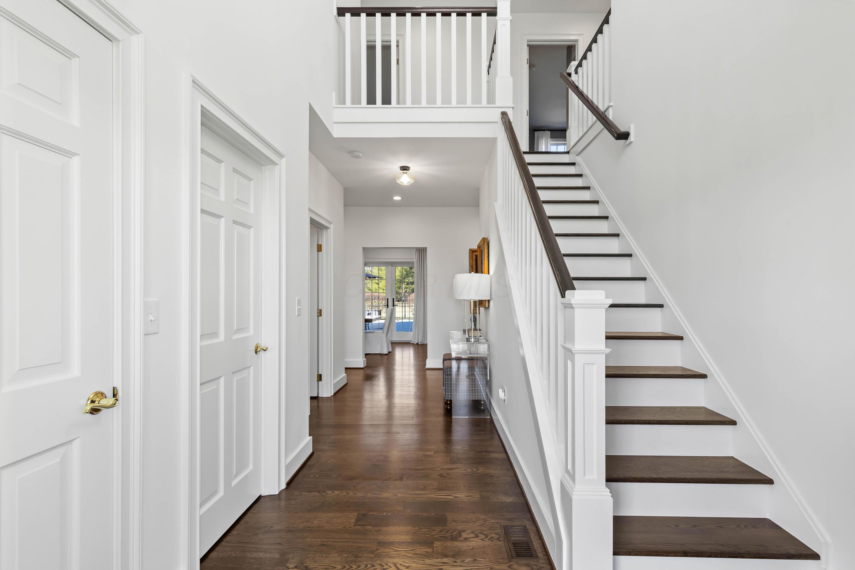 1364 Dale Ford Road Delaware, OH 43015 - Photo 8 of 112 • Hardwood flooring • White painted walls • Two-story ceiling • Coat closet • Chandelier • Sidelights by front door • New staircase
