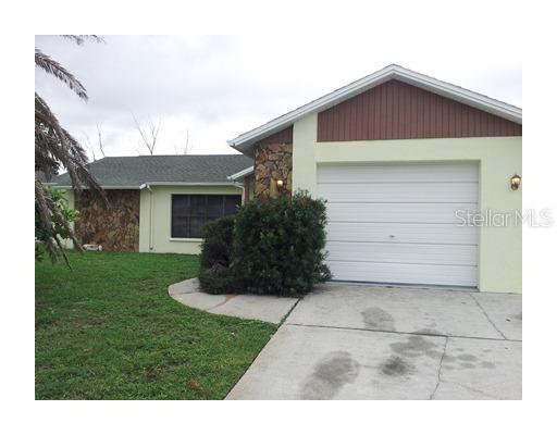 9417 Barnstead Lane Port Richey, FL 34668 - Photo 1 of 1 a front view of a house with a garden