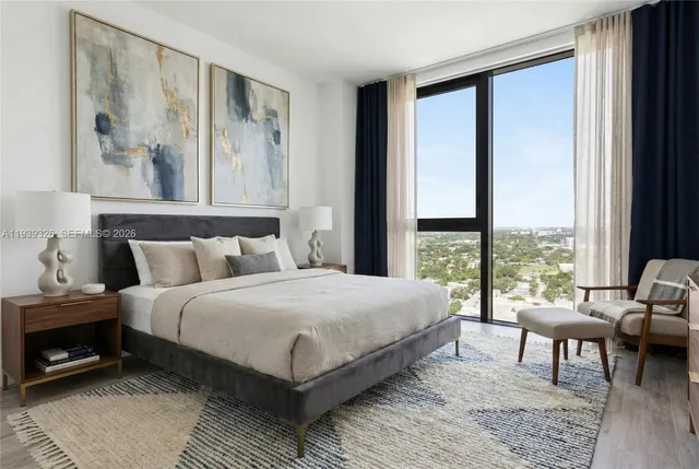 a bedroom with a bed and a large window