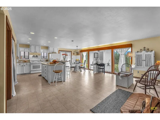 a living room with furniture and a table with garden view