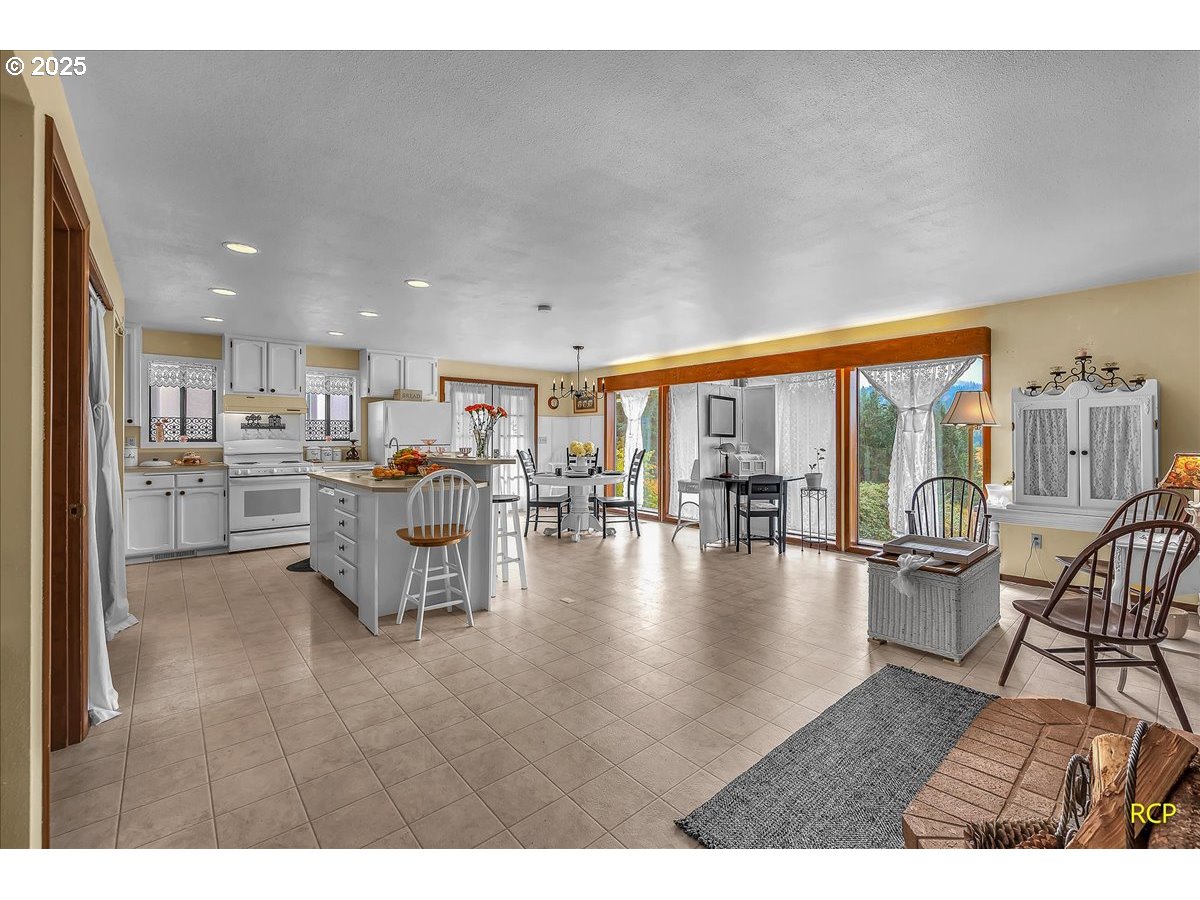 24312 Cardwell Hill Drive Philomath, OR 97370 - Photo 14 of 48 a living room with furniture and a table with garden view