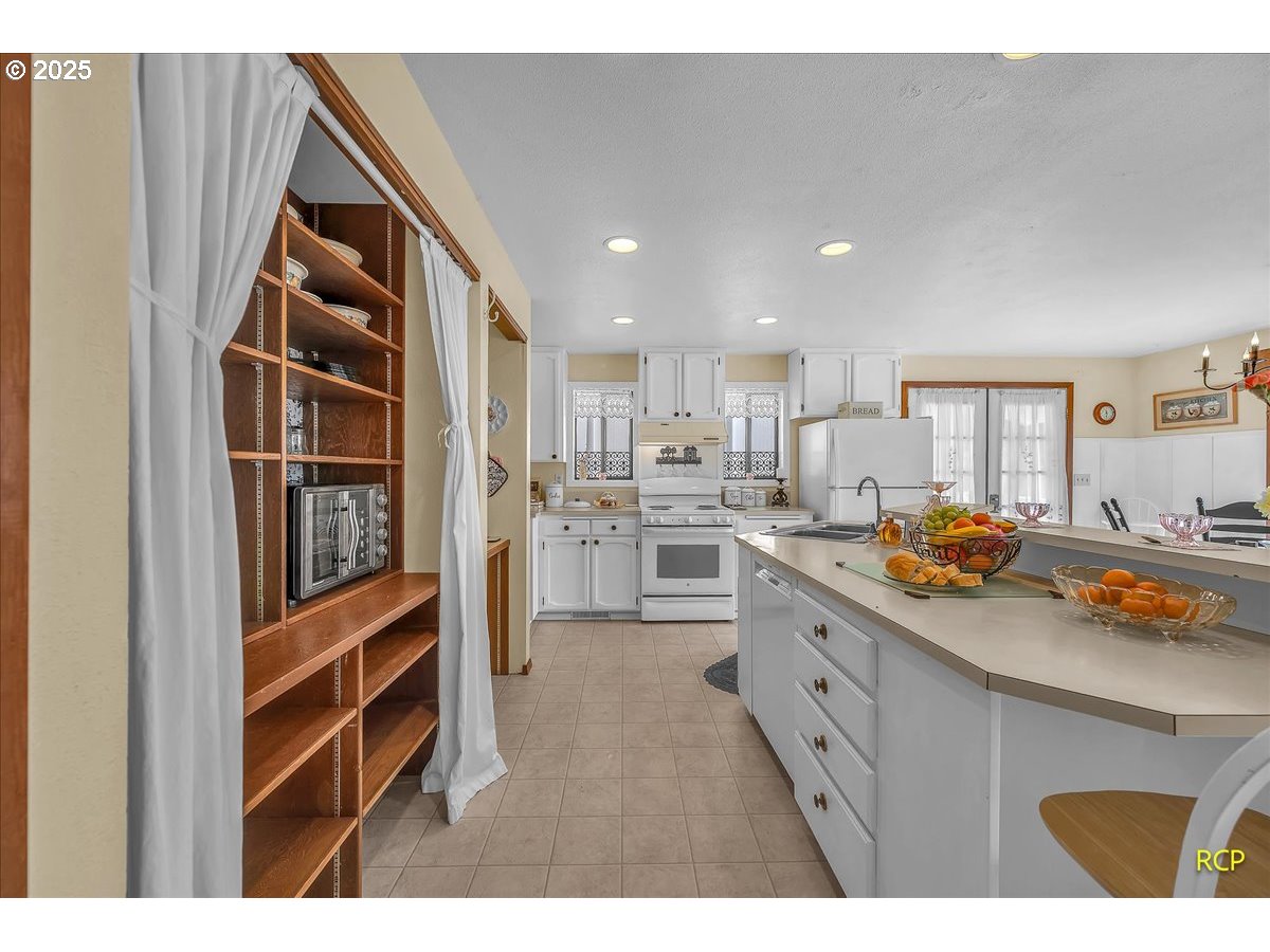 24312 Cardwell Hill Drive Philomath, OR 97370 - Photo 15 of 48 a kitchen with stainless steel appliances granite countertop a refrigerator and a sink