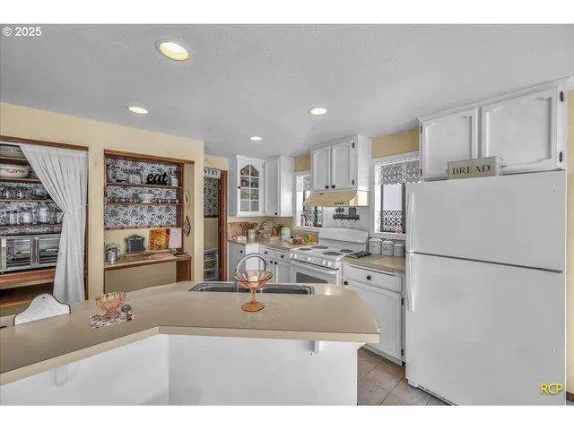 a kitchen with refrigerator and cabinets