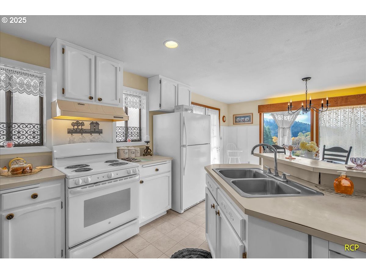 24312 Cardwell Hill Drive Philomath, OR 97370 - Photo 20 of 48 a kitchen that has a sink a stove and refrigerator