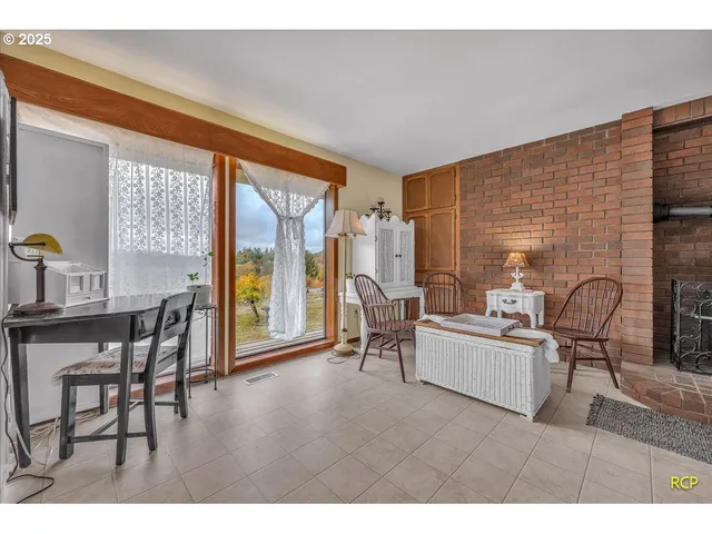 a living room with furniture a table and large windows