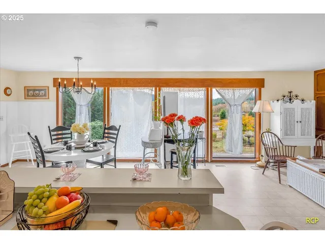 a dining room with furniture a rug and a large window