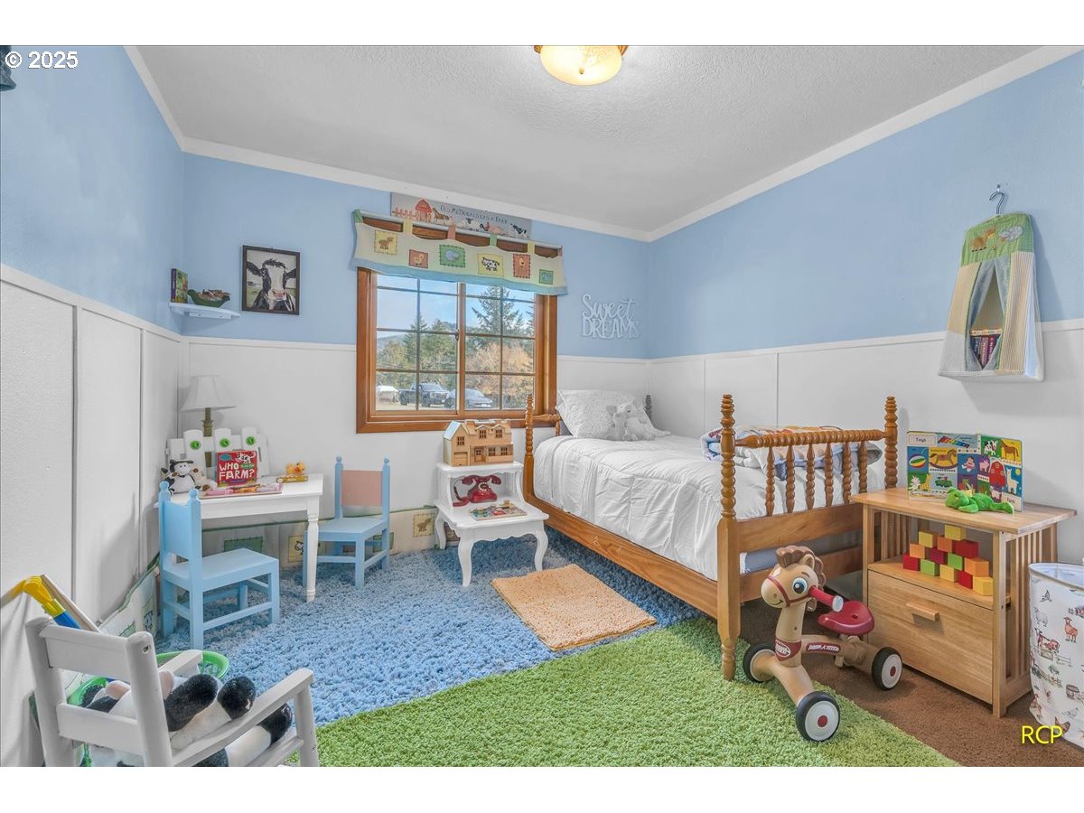 24312 Cardwell Hill Drive Philomath, OR 97370 - Photo 28 of 48 a bed room with a bed and a chair