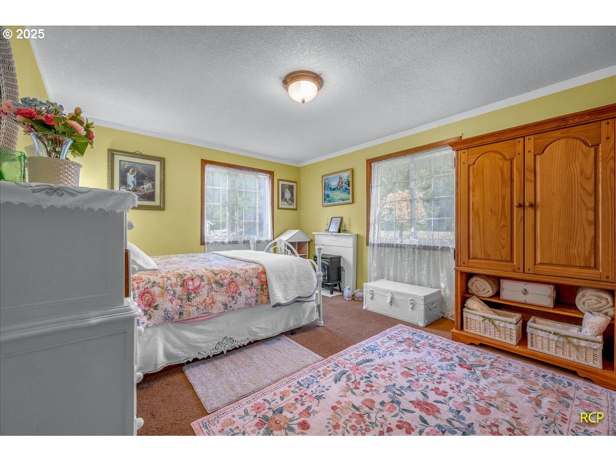 24312 Cardwell Hill Drive Philomath, OR 97370 - Photo 30 of 48 a bedroom with a bed dresser and a window