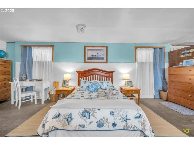 a bedroom with a large bed and a dresser