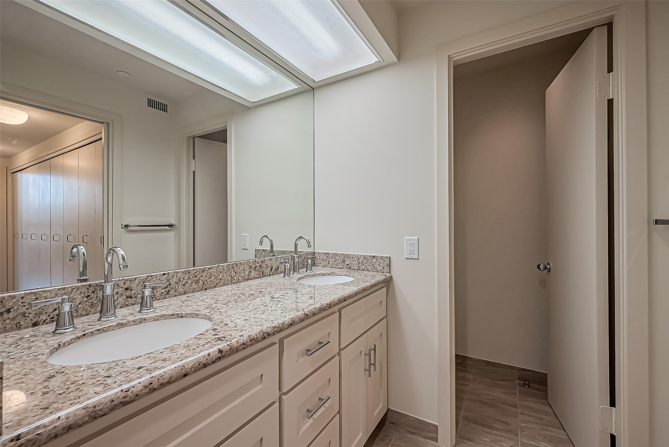 5100 San Felipe Street, Unit 34 Houston, TX 77056 - Photo 11 of 26 a bathroom with a granite countertop sink and a mirror
