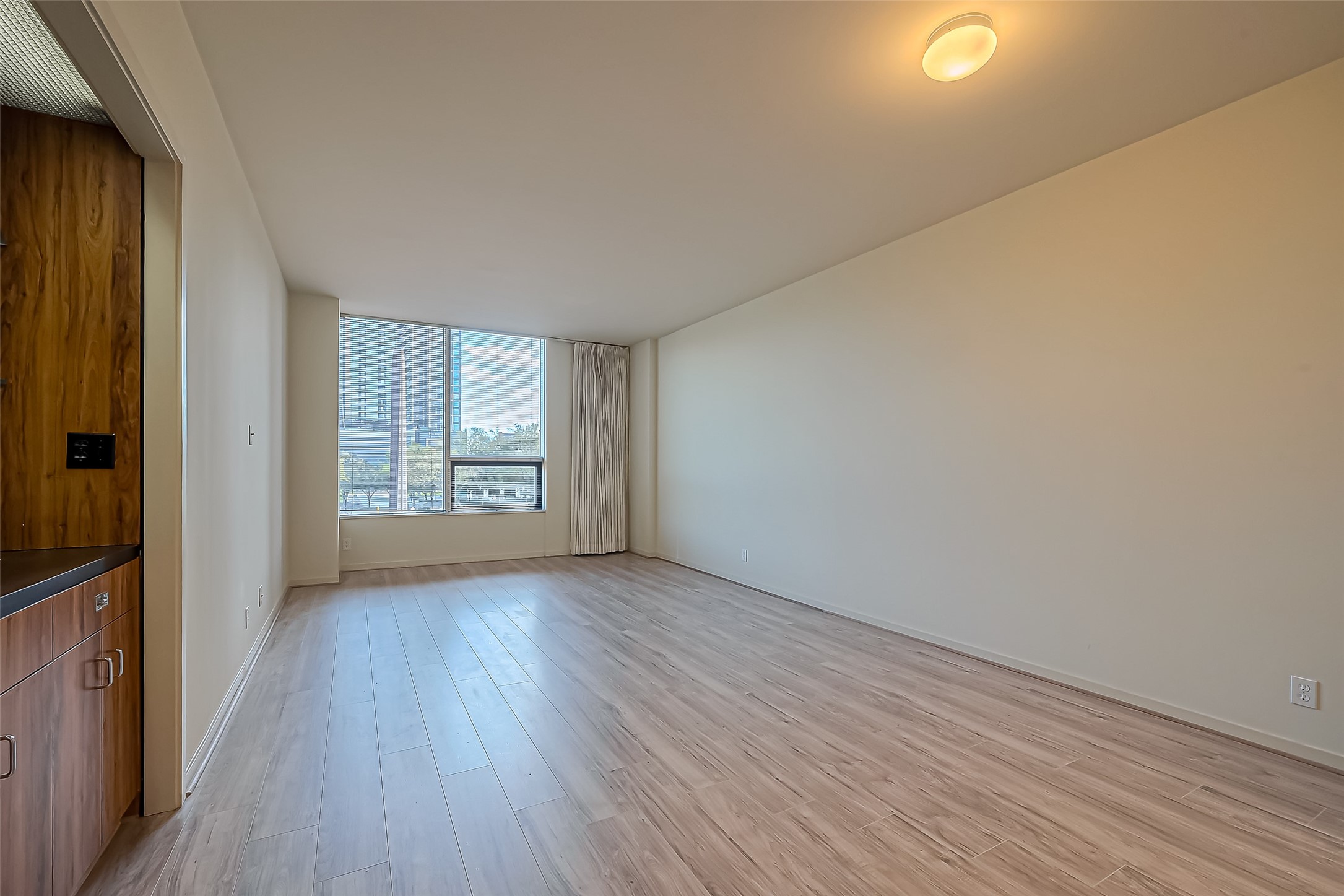 5100 San Felipe Street, Unit 34 Houston, TX 77056 - Photo 12 of 26 a view of an empty room with window and wooden floor