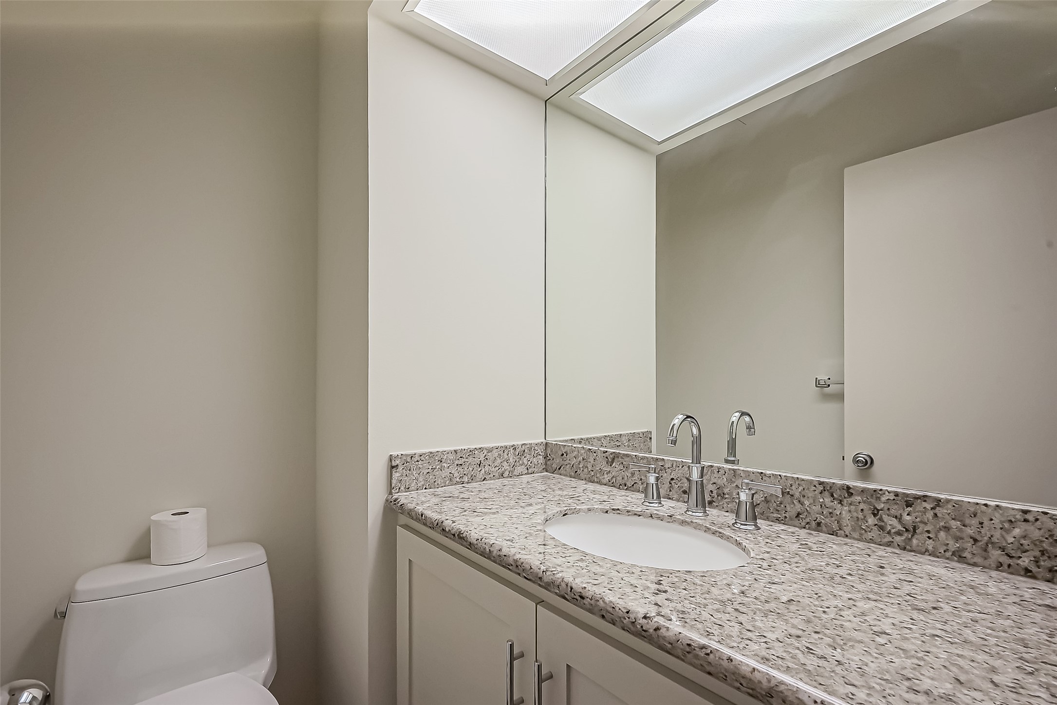 5100 San Felipe Street, Unit 34 Houston, TX 77056 - Photo 17 of 26 a bathroom with a granite countertop sink and a mirror