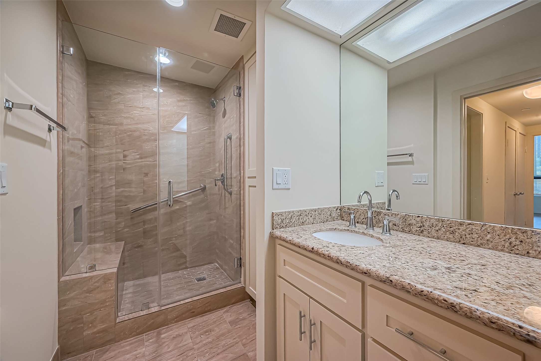 5100 San Felipe Street, Unit 34 Houston, TX 77056 - Photo 10 of 26 a bathroom with a granite countertop sink a shower and a mirror
