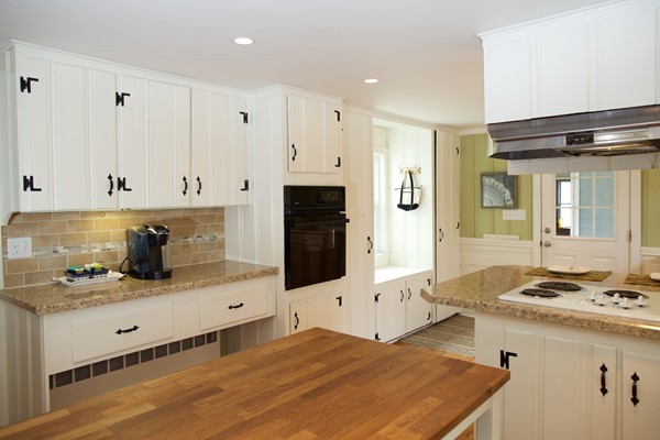 a kitchen with stainless steel appliances kitchen island granite countertop a refrigerator and a stove