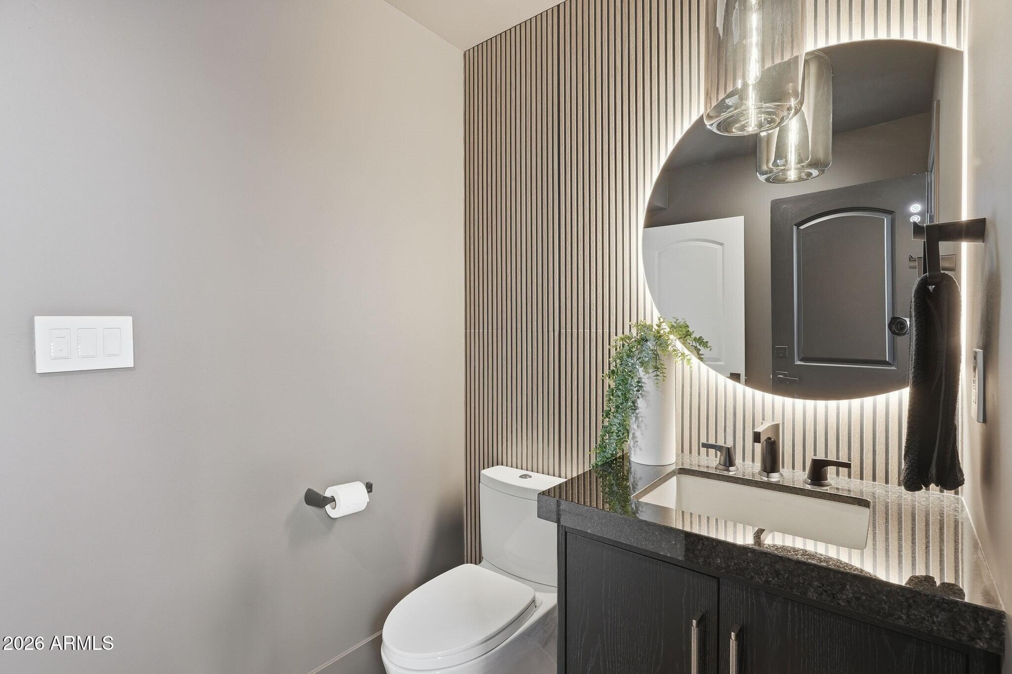 7475 East Gainey Ranch Road, Unit 7 Scottsdale, AZ 85258 - Photo 41 of 77 a bathroom with a toilet sink and mirror
