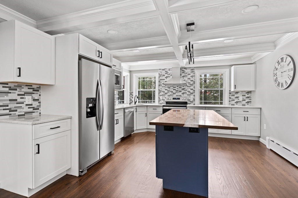233 Loudville Road Easthampton, MA 01027 - Photo 10 of 42 a kitchen with kitchen island white cabinets and stainless steel appliances