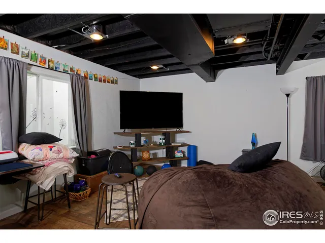 a bedroom with furniture and a flat screen tv