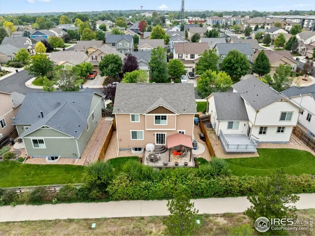 an aerial view of a house with a garden and houses