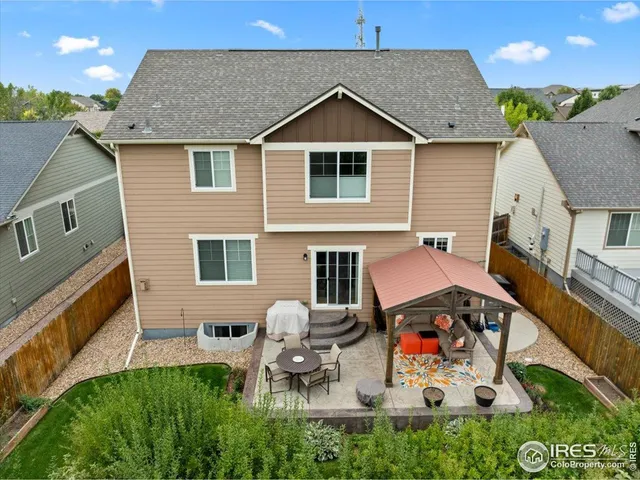 a backyard of a house with table and chairs