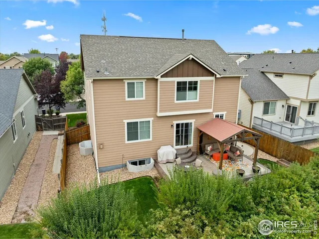 a view of a house with backyard sitting area and garden