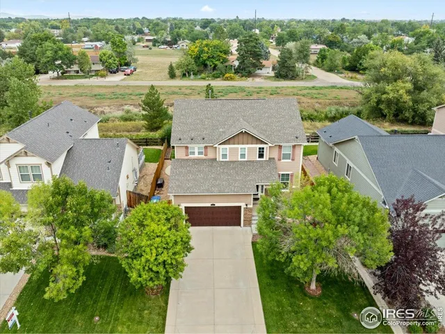an aerial view of a house with a yard and lake view