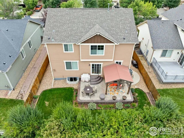 an aerial view of a house with table and chairs