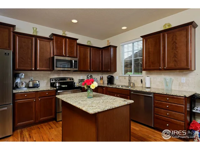 a kitchen with a sink a stove a microwave and cabinets