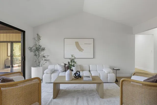 a living room with fireplace furniture and a floor to ceiling window