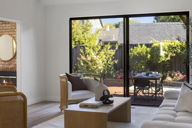 a dining room with furniture a chandelier and wooden floor