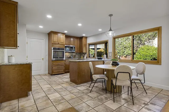 a living room with furniture and a painting on the wall