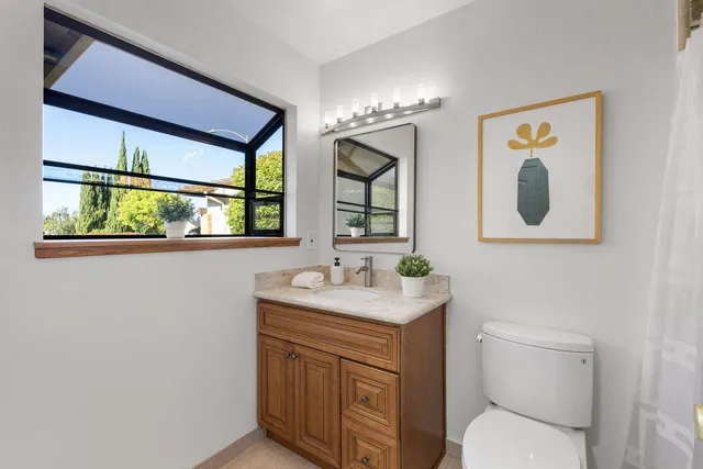 a vase of flowers sitting on a table in a kitchen