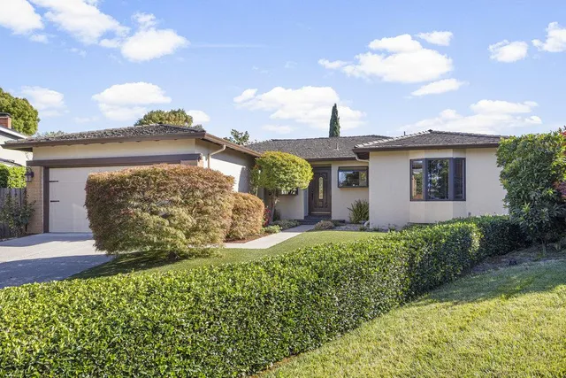 a living room with fireplace furniture and a large window